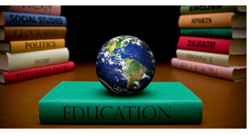 A globe on a green book labeled 'Education' with stacks of books in the background.
